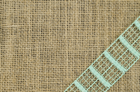 Frame of green ribbon on linen backgroundの写真素材