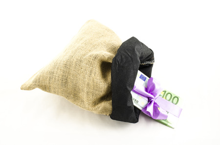 Money with pink bow in jute bagの写真素材