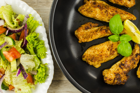 Fried chicken with vegetables saladの写真素材