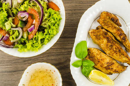 Fried chicken with vegetables saladの写真素材