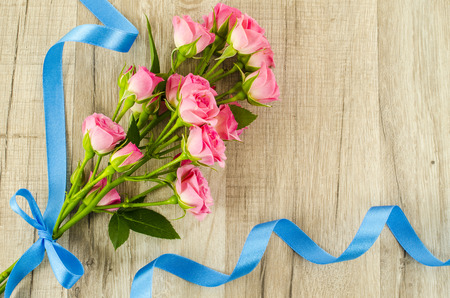 Empty wooden with colorful flowers and blue ribbonの写真素材