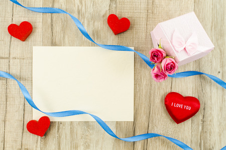 Empty card with rose flower, gift box, heart and ribbonの写真素材