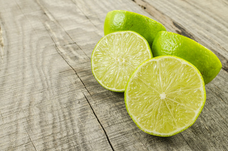 Fresh limes on wooden table