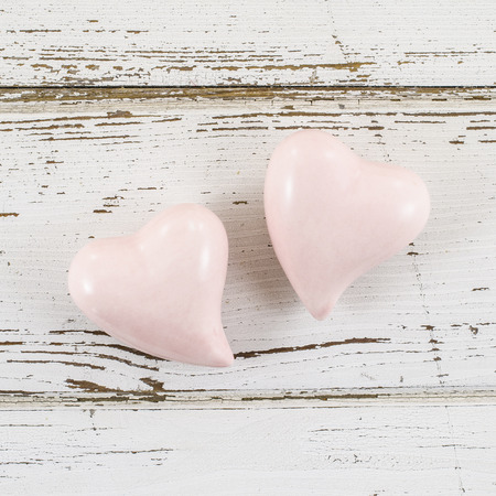Pink hearts on wooden tableの写真素材