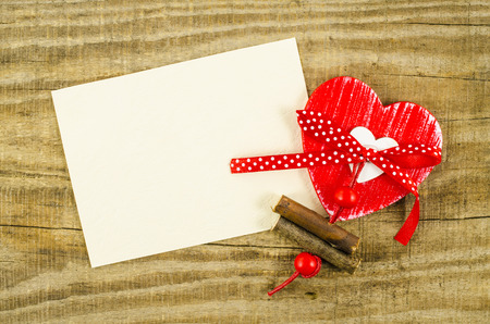 Empty card with red heart on wooden tableの写真素材