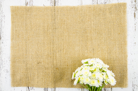 Fresh flowers on jute backgroundの写真素材