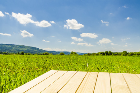 Empty wooden table with landscape backgroundの写真素材