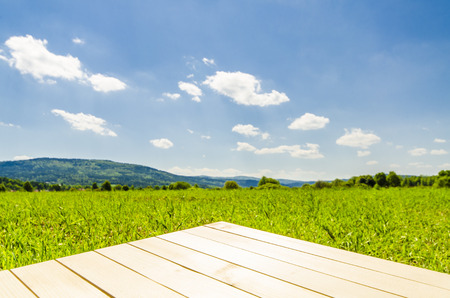 Empty wooden table with landscape backgroundの写真素材
