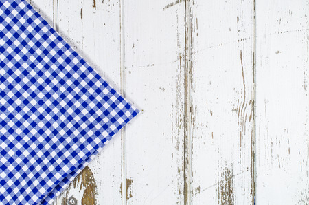 Blue tablecloth over wooden tableの写真素材