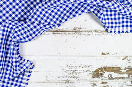 Blue folded tablecloth over wooden tableの写真素材