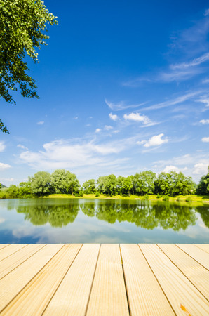 Empty wooden table with landscape backgroundの写真素材