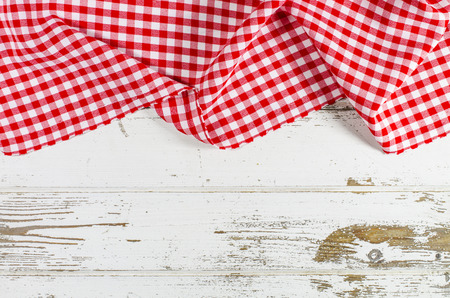 Red folded tablecloth over wooden tableの写真素材