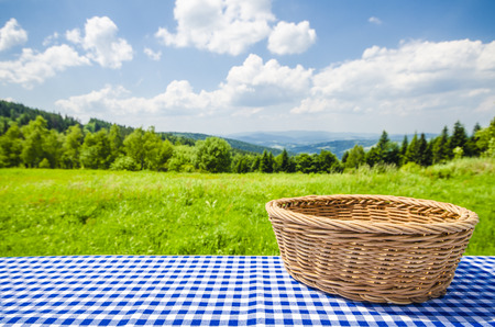 Empty table with wicker basket and landscape backgroundの写真素材