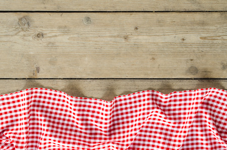 Red folded tablecloth over wooden table