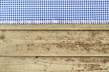 Blue tablecloth over wooden tableの写真素材