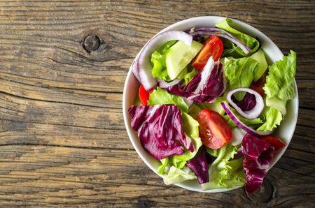 Fresh vegetables salad on wooden tableの写真素材