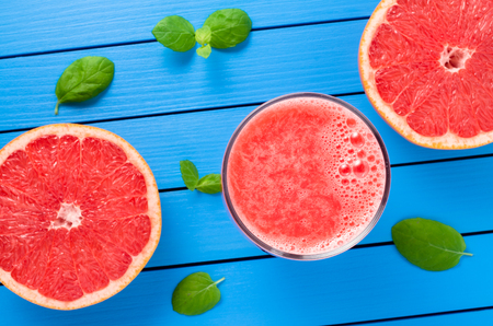 Grapefruit juice on blue wooden tableの写真素材