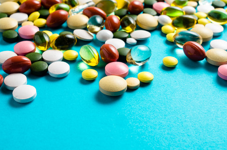 Colorful pills on blue background