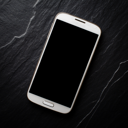 White mobile phone on dark backgroundの写真素材