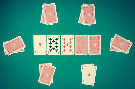 Playing cards on green table