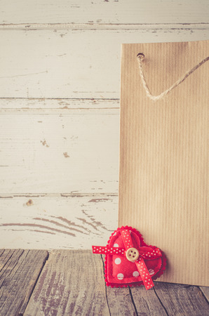 Paper gift bag on wooden tableの写真素材