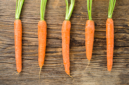 Fresh carrots on wooden table