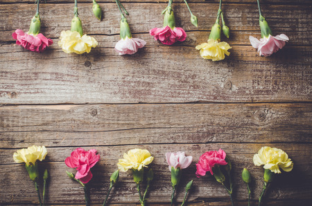 Carnation flowers on wooden tableの写真素材