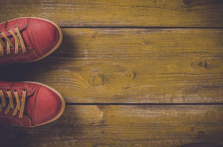 Red shoes on yellow wooden floorの写真素材