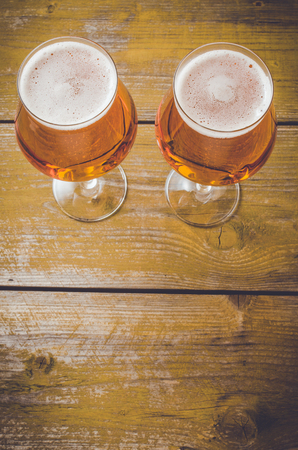 Beer glass on an old yellow wooden table. Close upの写真素材