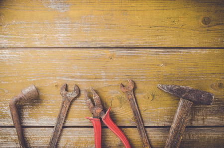 Old rusty tools on wooden tableの写真素材
