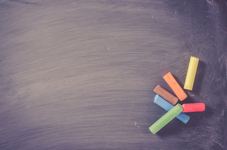 Chalk pieces on dark wiped chalkboardの写真素材