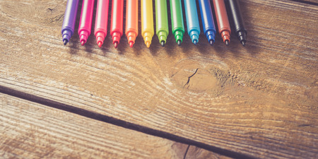 Colorful markers on yellow wooden table. Close upの写真素材