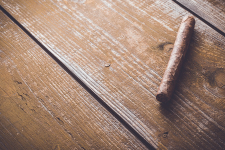 Cuban cigar on an old wooden tableの写真素材
