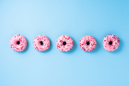Pink donuts on blue backgroundの写真素材