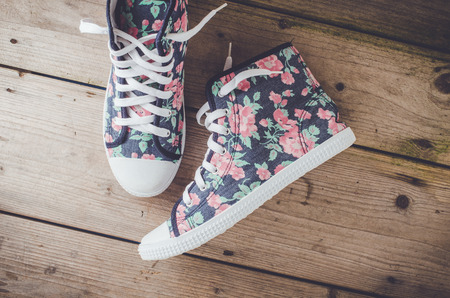 Colorful sneakers on wooden floorの写真素材