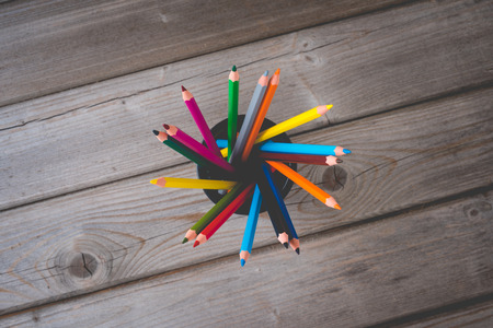 Colorful pencils on wooden table. Close upの写真素材