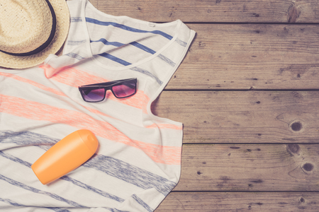 Men's beach clothes and accessories on wooden tableの写真素材