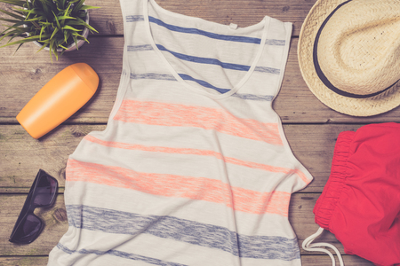 Men's beach clothes and accessories on wooden tableの写真素材