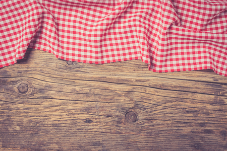 Checkered tablecloth on wooden tableの写真素材