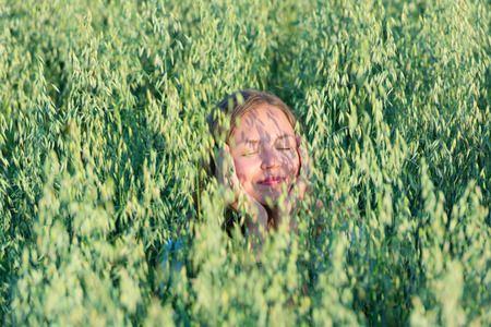 Beautiful young woman in a wheat fieldの写真素材