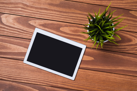 White digital tablet on wooden tableの写真素材