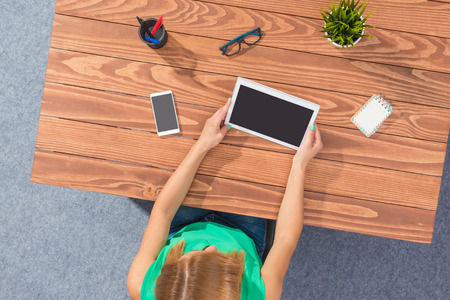 Overhead shot of a young business woman working in officeの写真素材