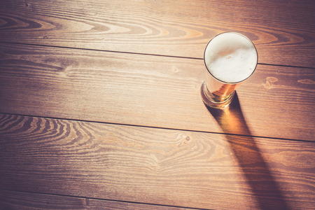 Beer glass on wooden tableの写真素材