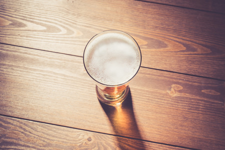 Beer glass on wooden tableの写真素材