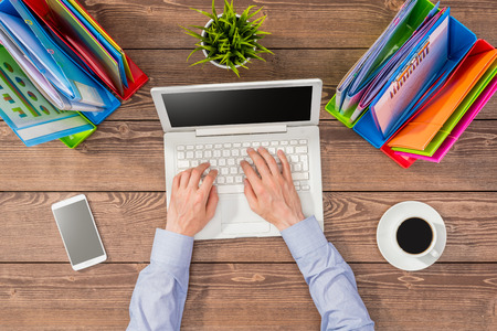 Business man using computer in an officeの写真素材