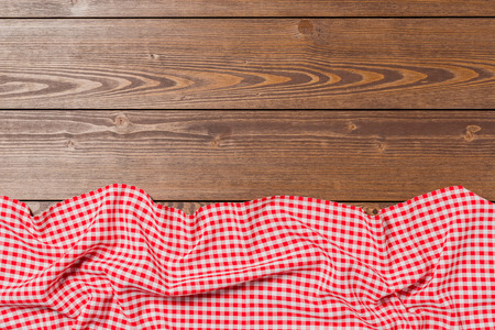 Checkered tablecloth on wooden tableの写真素材