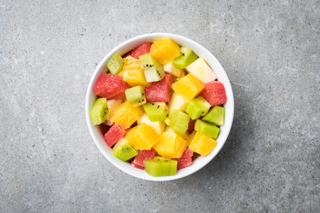 Fresh fruit salad on gray stone table