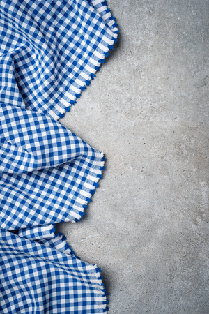 Blue folded tablecloth on gray stone tableの写真素材
