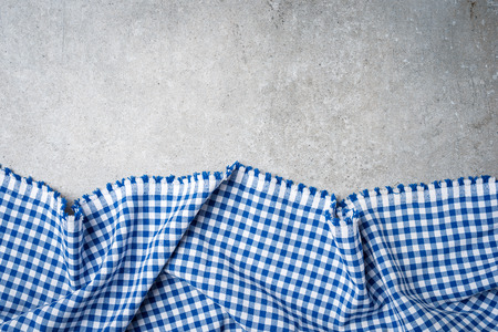 Blue folded tablecloth on gray stone table