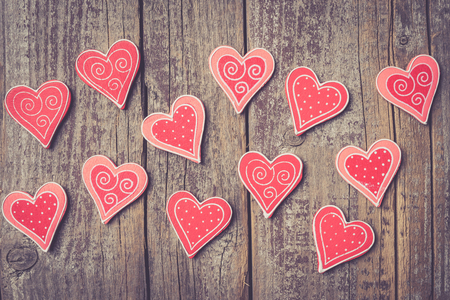 Red hearts on an old wooden table. Valentine's Day backgroundの写真素材